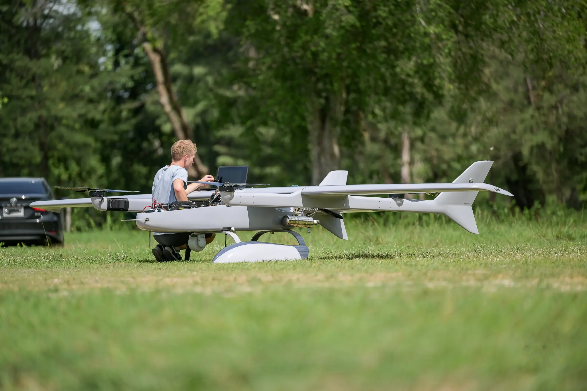 An engineer is working on a UAV with Gimbal camera.